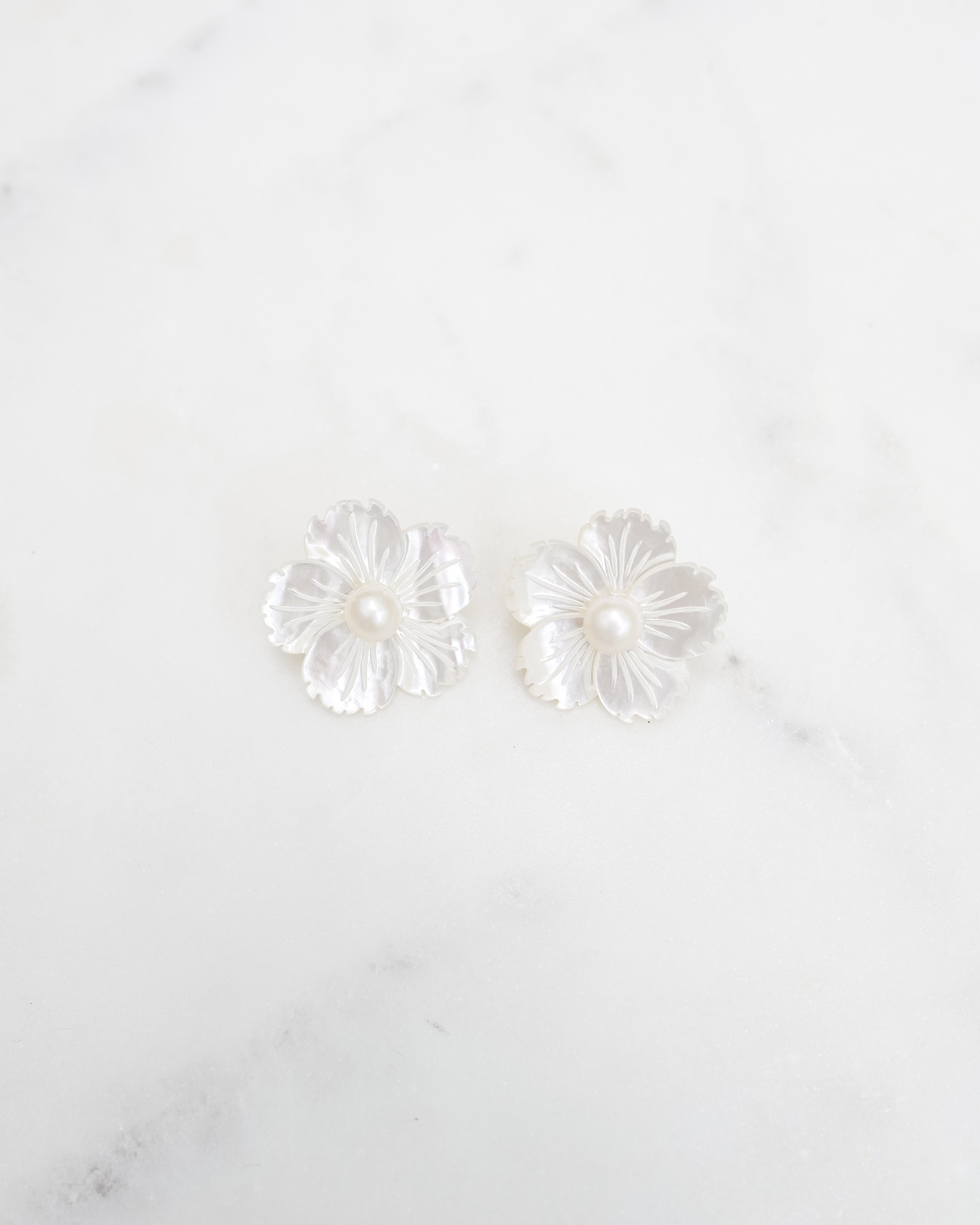 Mother of pearl flower earrings with a pearl center