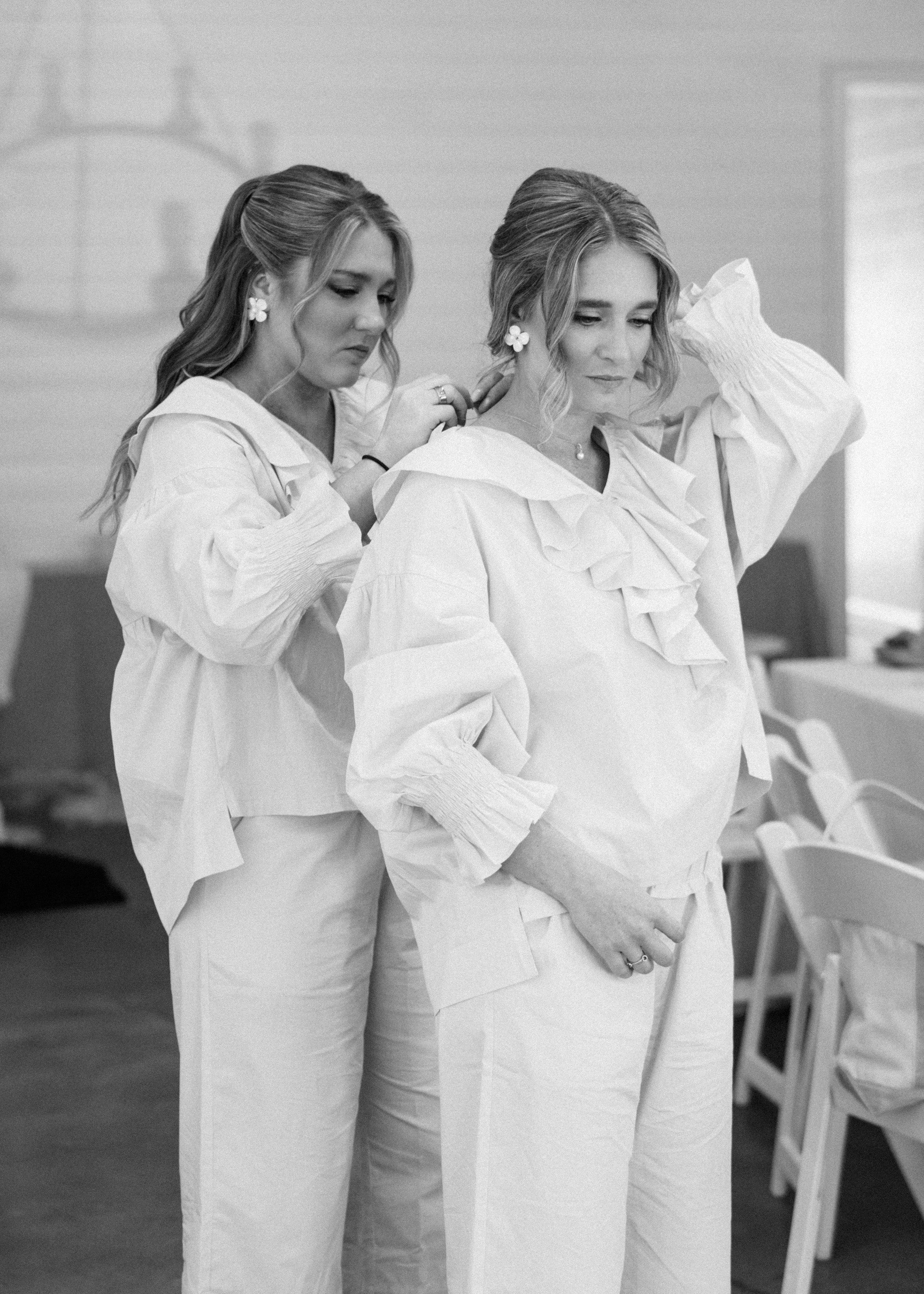 Two women in pajamas getting ready