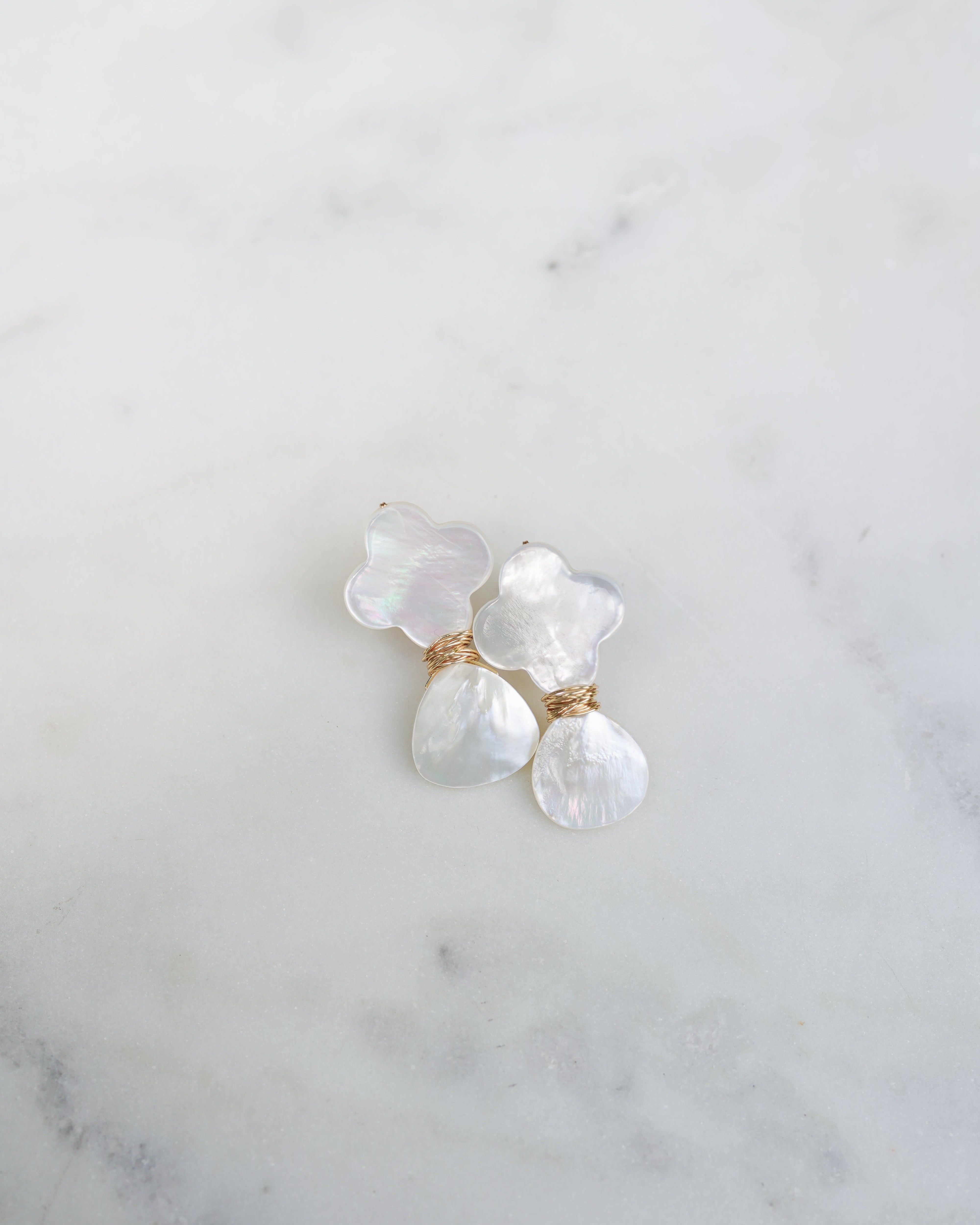Pearl earrings on a marble surface