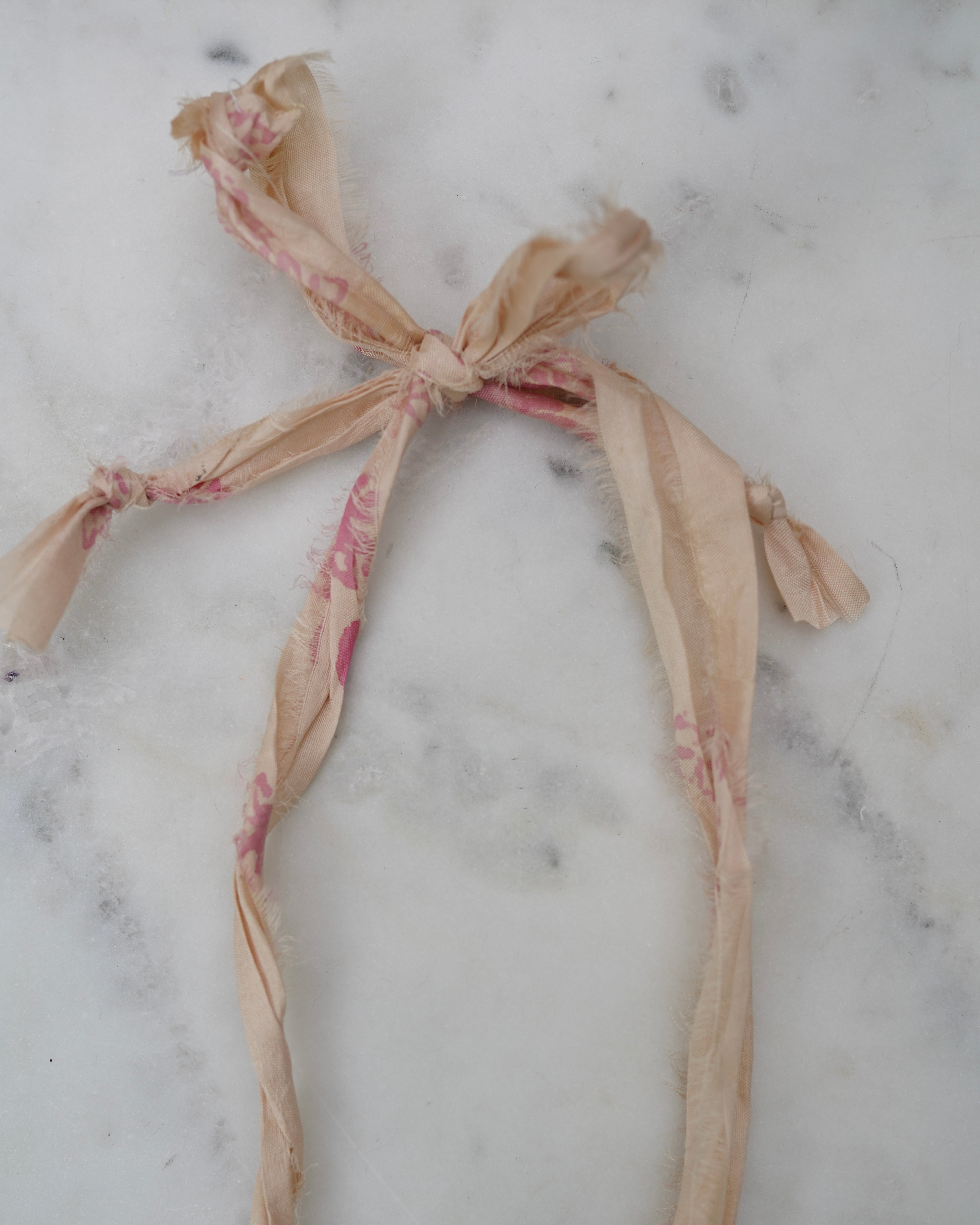 Decorative ribbon in bow on a marble surface