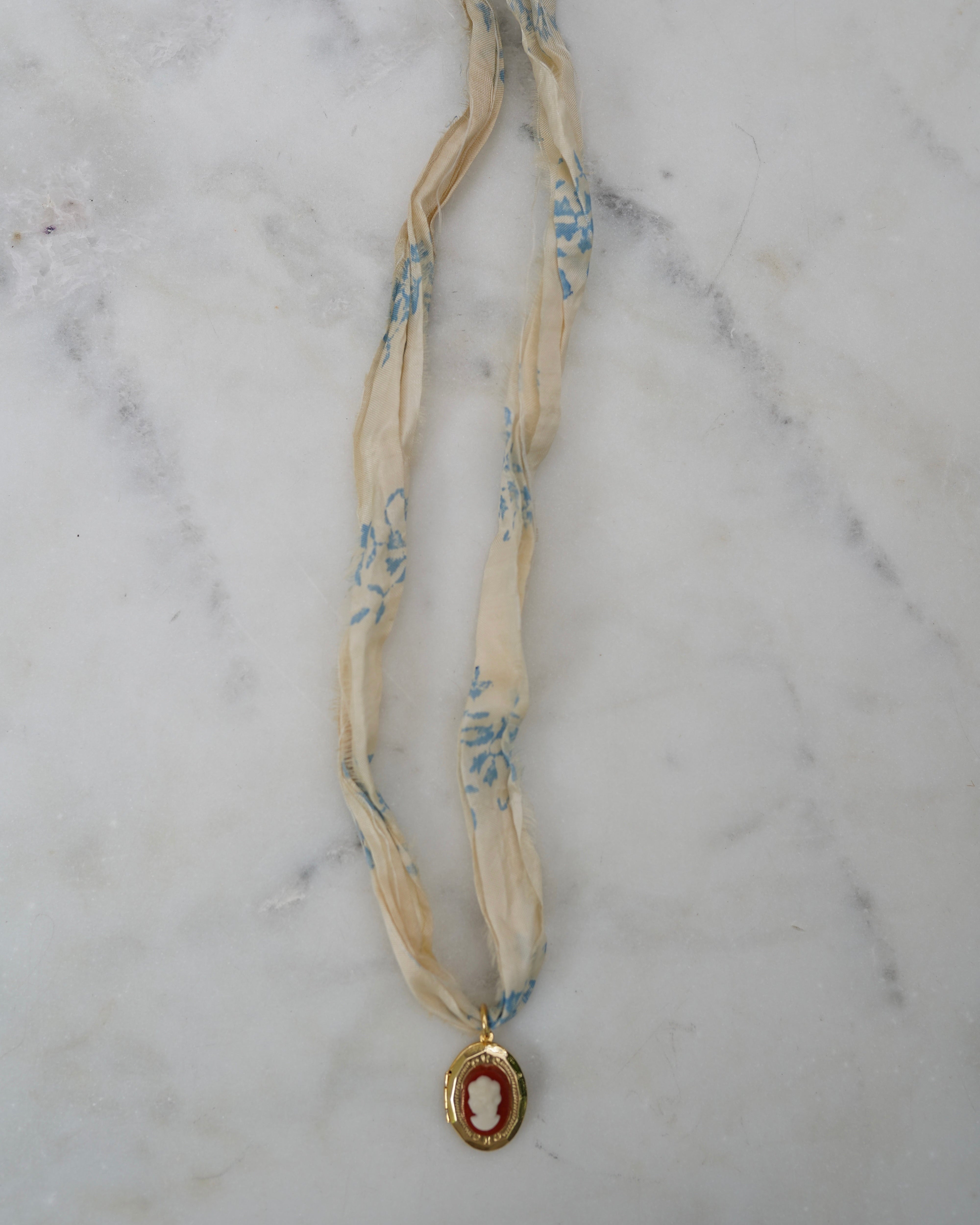 Necklace with a pendant on a marble surface