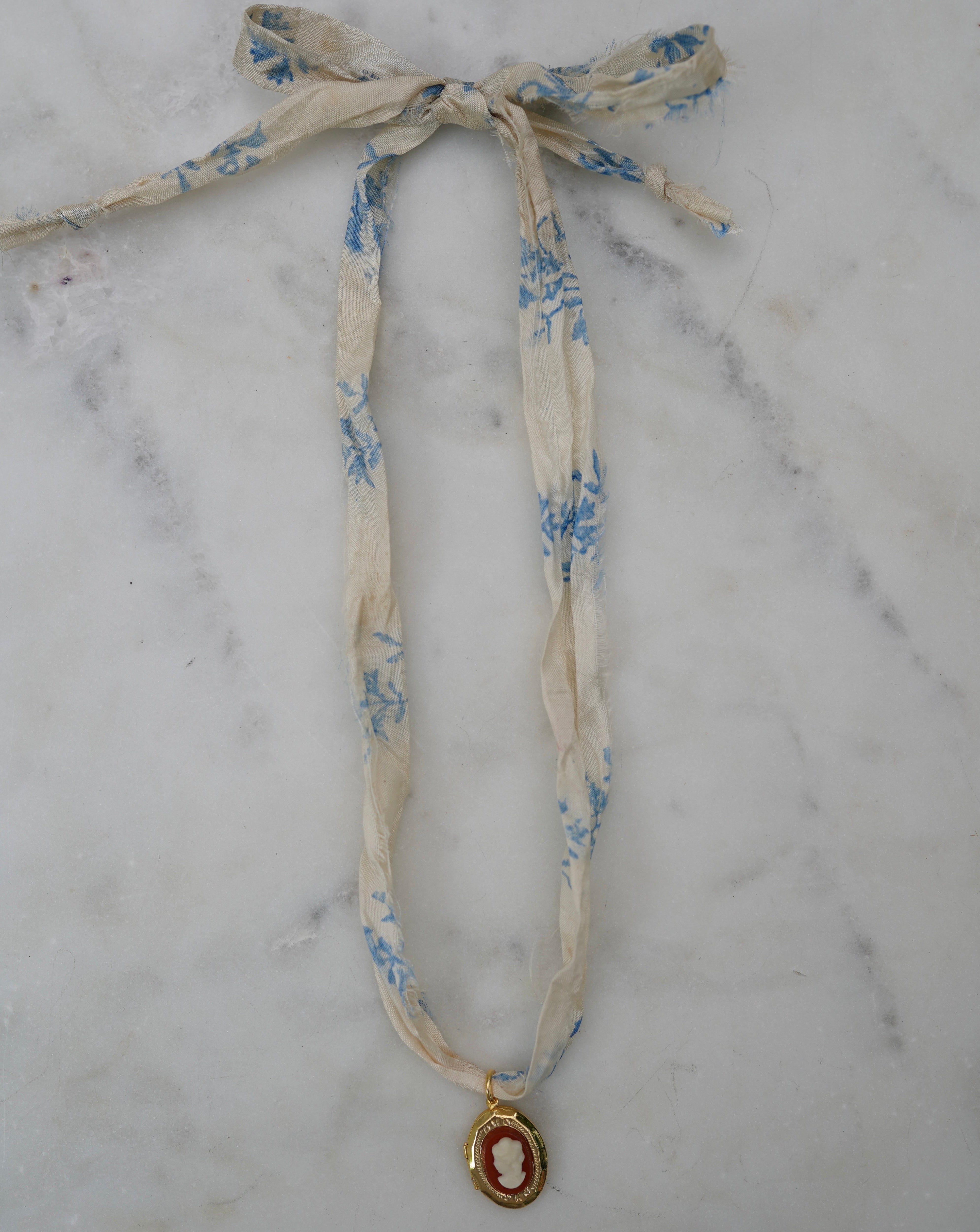 Floral ribbon with a pendant on a marble surface